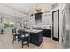 Open kitchen with modern pendant lighting, two-tone cabinets, island with stools, and stainless appliances at 558 Oxbow Dr., Myrtle Beach, SC 29579