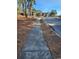 A sidewalk adjacent to a street lined with trees and well-maintained lawns in a quiet neighborhood at 558 Oxbow Dr., Myrtle Beach, SC 29579