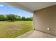 A patio with a view of a large grassy backyard, complete with trees at 572 Woodland Farms Circle, Aynor, SC 29511