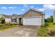 Inviting one-story home with a well-maintained lawn and attached one car garage at 572 Woodland Farms Circle, Aynor, SC 29511