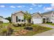Exterior elevation of home featuring tan siding, lawn and landscaping at 572 Woodland Farms Circle, Aynor, SC 29511