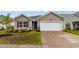 Charming one-story home featuring low-maintenance landscaping and an attached garage at 572 Woodland Farms Circle, Aynor, SC 29511