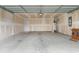 A large garage with exposed ceiling beams and a concrete floor at 572 Woodland Farms Circle, Aynor, SC 29511