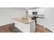 Open kitchen with granite counters, island with sink, stainless appliances, and ample cabinet space at 572 Woodland Farms Circle, Aynor, SC 29511