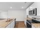 Bright kitchen features granite counters, stainless appliances, and white cabinetry at 572 Woodland Farms Circle, Aynor, SC 29511