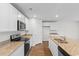 Kitchen boasts granite countertops, stainless steel appliances, and white cabinets at 572 Woodland Farms Circle, Aynor, SC 29511