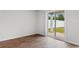 Room with sliding glass door leading to backyard, wood-look flooring, and white walls at 572 Woodland Farms Circle, Aynor, SC 29511