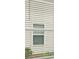 A window with white blinds, with a view of the home's siding and lawn at 572 Woodland Farms Circle, Aynor, SC 29511