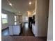 Bright kitchen with stainless steel appliances, island, white cabinets, and smooth transition to dining area at 594 Castillo Dr., Loris, SC 29569