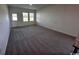 Carpeted living space with natural light from multiple windows and open layout for versatile furniture arrangement at 594 Castillo Dr., Loris, SC 29569