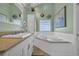 Bright bathroom featuring double sinks, a large mirror, granite countertops, soaking tub and a tiled floor at 6001 - Mh 17A South Kings Hwy., Myrtle Beach, SC 29575