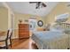 Bright bedroom with a ceiling fan, wooden dresser, and a comfortable bed with a seashell patterned comforter at 6001 - Mh 17A South Kings Hwy., Myrtle Beach, SC 29575