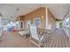 Expansive covered deck with lounge seating, dining table and chairs, perfect for entertaining or relaxing outdoors at 6001 - Mh 17A South Kings Hwy., Myrtle Beach, SC 29575