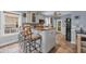 Kitchen island featuring barstool seating, granite countertops, and tile flooring at 6001 - Mh 17A South Kings Hwy., Myrtle Beach, SC 29575