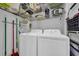 Functional laundry room with washer, dryer, wire shelves, and cleaning supplies at 6001 - Mh 17A South Kings Hwy., Myrtle Beach, SC 29575