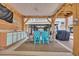 Covered outdoor kitchen and dining area with blue cabinets and chairs at 6001 - Mh 17A South Kings Hwy., Myrtle Beach, SC 29575