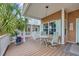 Charming porch with seating area and lush tropical plants on a sunny day at 6001 - Mh 17A South Kings Hwy., Myrtle Beach, SC 29575