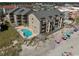 Aerial view of condo building on the beach with an outdoor swimming pool, balconies, and ocean views at 618 N Waccamaw Dr. # B7, Garden City Beach, SC 29576