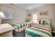 Bright bedroom featuring two twin beds with striped bedding and beach-themed artwork at 618 N Waccamaw Dr. # B7, Garden City Beach, SC 29576