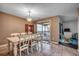 Elegant dining area with seating for six and a sliding glass door leading to a patio at 618 N Waccamaw Dr. # B7, Garden City Beach, SC 29576
