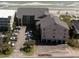 View of an oceanfront condo building with parking and beach access at 618 N Waccamaw Dr. # B7, Garden City Beach, SC 29576