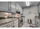 Well-equipped kitchen featuring granite countertops, stainless steel appliances, and ample cabinet space at 618 N Waccamaw Dr. # B7, Garden City Beach, SC 29576