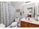 The bathroom features a vanity with a sink, toilet, and shower with a patterned shower curtain at 637 Botany Loop # 64, Murrells Inlet, SC 29576