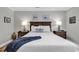 Cozy bedroom with a wood-framed bed, two side tables, and decorative wall art at 637 Botany Loop # 64, Murrells Inlet, SC 29576