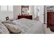 Cozy bedroom featuring a decorative quilt, wooden dresser, and plantation shutters for ample natural light at 637 Botany Loop # 64, Murrells Inlet, SC 29576