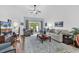Bright living room features hardwood floors, ceiling fan, and sliding glass doors to a private patio at 637 Botany Loop # 64, Murrells Inlet, SC 29576