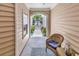 View of front yard through arched entryway of covered front porch with seating at 637 Botany Loop # 64, Murrells Inlet, SC 29576