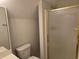 This bathroom features a glass shower with gold trim and a sink and toilet at 6542 Wellington Dr., Murrells Inlet, SC 29576