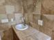 Chic bathroom with a stone tile countertop and neutral tile walls for a luxurious feel at 6542 Wellington Dr., Murrells Inlet, SC 29576