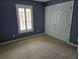 Cozy bedroom featuring plush carpeting, a closet, and natural light from the window at 6542 Wellington Dr., Murrells Inlet, SC 29576