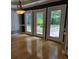 Dining area with hardwood floors and three sets of doors leading to an outdoor patio at 6542 Wellington Dr., Murrells Inlet, SC 29576