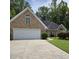 Charming brick home featuring an attached two-car garage and well-maintained landscaping at 6542 Wellington Dr., Murrells Inlet, SC 29576