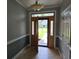 Elegant foyer with tile flooring and a decorative front door with sidelights at 6542 Wellington Dr., Murrells Inlet, SC 29576