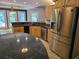 Modern kitchen equipped with stainless steel appliances, granite countertops, and wooden cabinetry at 6542 Wellington Dr., Murrells Inlet, SC 29576