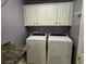 The laundry room features modern appliances and ample storage space with clean white cabinets and dark hardware at 6542 Wellington Dr., Murrells Inlet, SC 29576