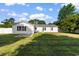 Spacious backyard featuring a white fence, outbuilding, and lush green lawn at 704 Bonnie Dr., Myrtle Beach, SC 29588