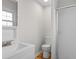 Bathroom featuring a white sink, toilet, and shower with a glass door at 704 Bonnie Dr., Myrtle Beach, SC 29588