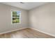 Bright bedroom featuring hardwood floors and a large window with a backyard view at 704 Bonnie Dr., Myrtle Beach, SC 29588