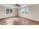 Bedroom boasting hardwood flooring, a modern ceiling fan, and abundant natural light from the windows at 704 Bonnie Dr., Myrtle Beach, SC 29588