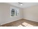 Bedroom featuring hardwood floors, a ceiling fan, and large windows with a backyard view at 704 Bonnie Dr., Myrtle Beach, SC 29588