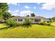 A well-maintained white house with a green lawn and beautiful landscaping is ready for move in at 704 Bonnie Dr., Myrtle Beach, SC 29588