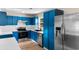 Well-equipped kitchen featuring stainless steel appliances, blue cabinets, and white backsplash is spacious and modern at 704 Bonnie Dr., Myrtle Beach, SC 29588