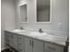 Bright bathroom features double sinks with marble countertops and gray cabinetry at 71 Mohican Dr., Georgetown, SC 29440