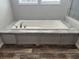 Built-in bathtub with marble surround and gray base at 71 Mohican Dr., Georgetown, SC 29440