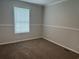 Cozy bedroom with neutral carpeting, base molding and natural light from one window at 71 Mohican Dr., Georgetown, SC 29440