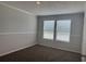Bright, carpeted bedroom with two windows and base molding throughout at 71 Mohican Dr., Georgetown, SC 29440